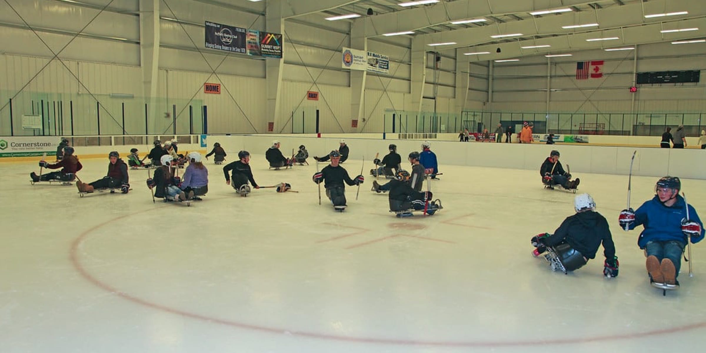 a group of people playing sled hockey